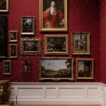 Free Discover classic art in an elegantly designed gallery space with red ornate walls. Stock Photo